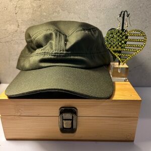 Green Utility Cap and rhinestone earrings.